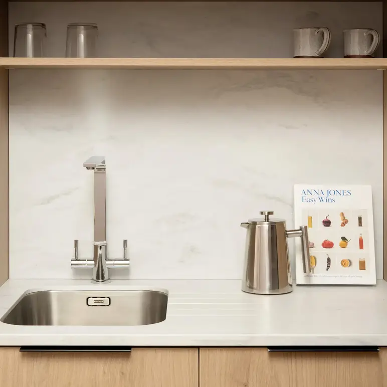 a sink and a book on a shelf