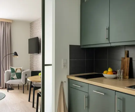 a kitchen with a bowl of fruit on a countertop