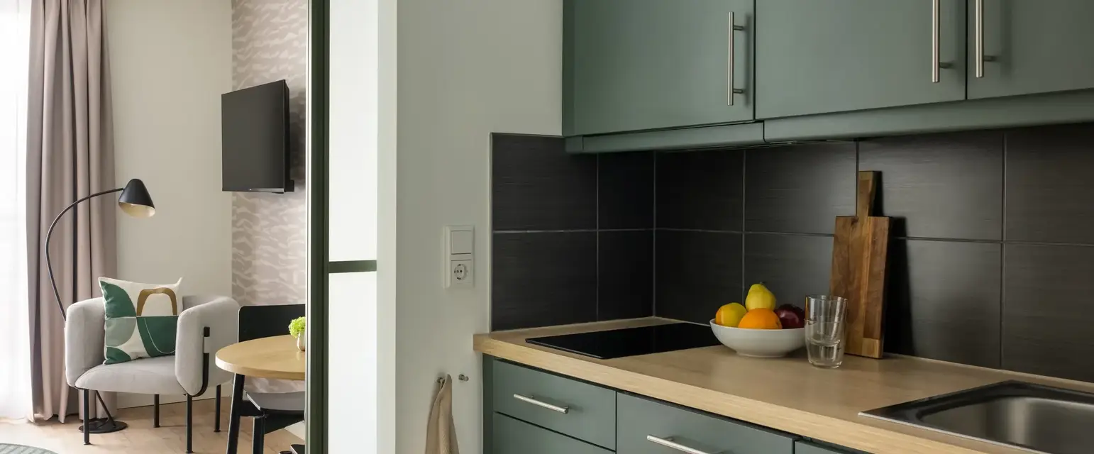 a kitchen with a bowl of fruit on a countertop