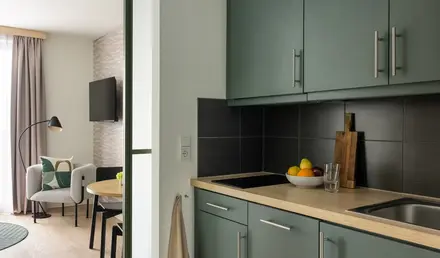 a kitchen with a bowl of fruit on a countertop