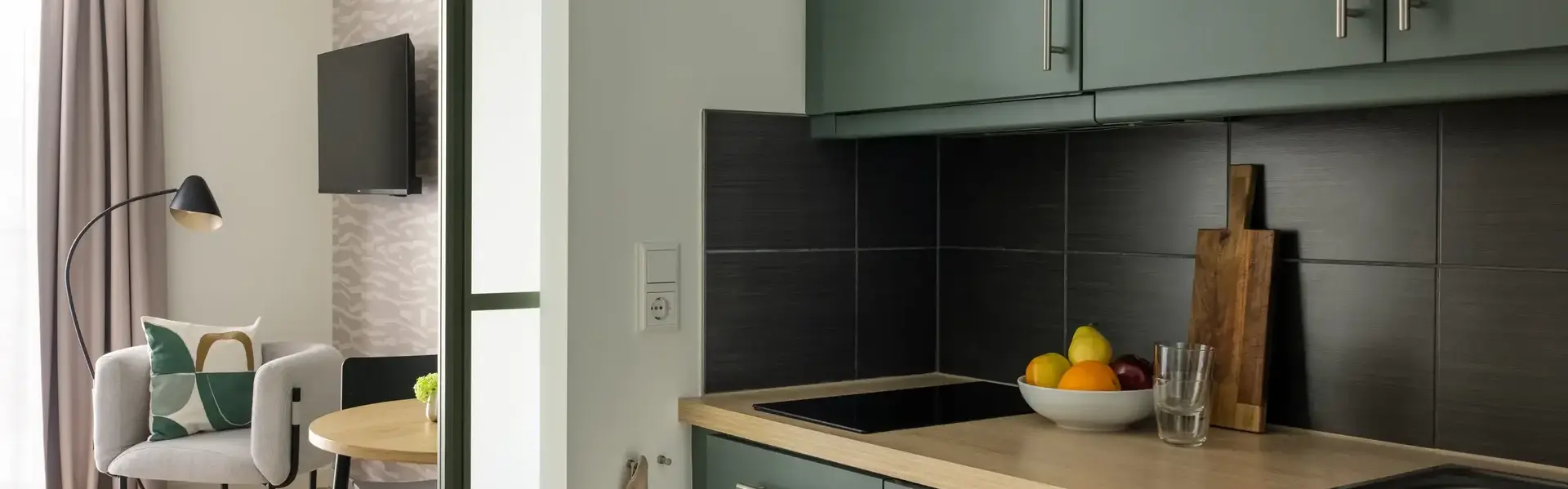 a kitchen with a bowl of fruit on a countertop