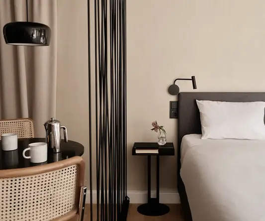 a bed with a white sheet and a black table