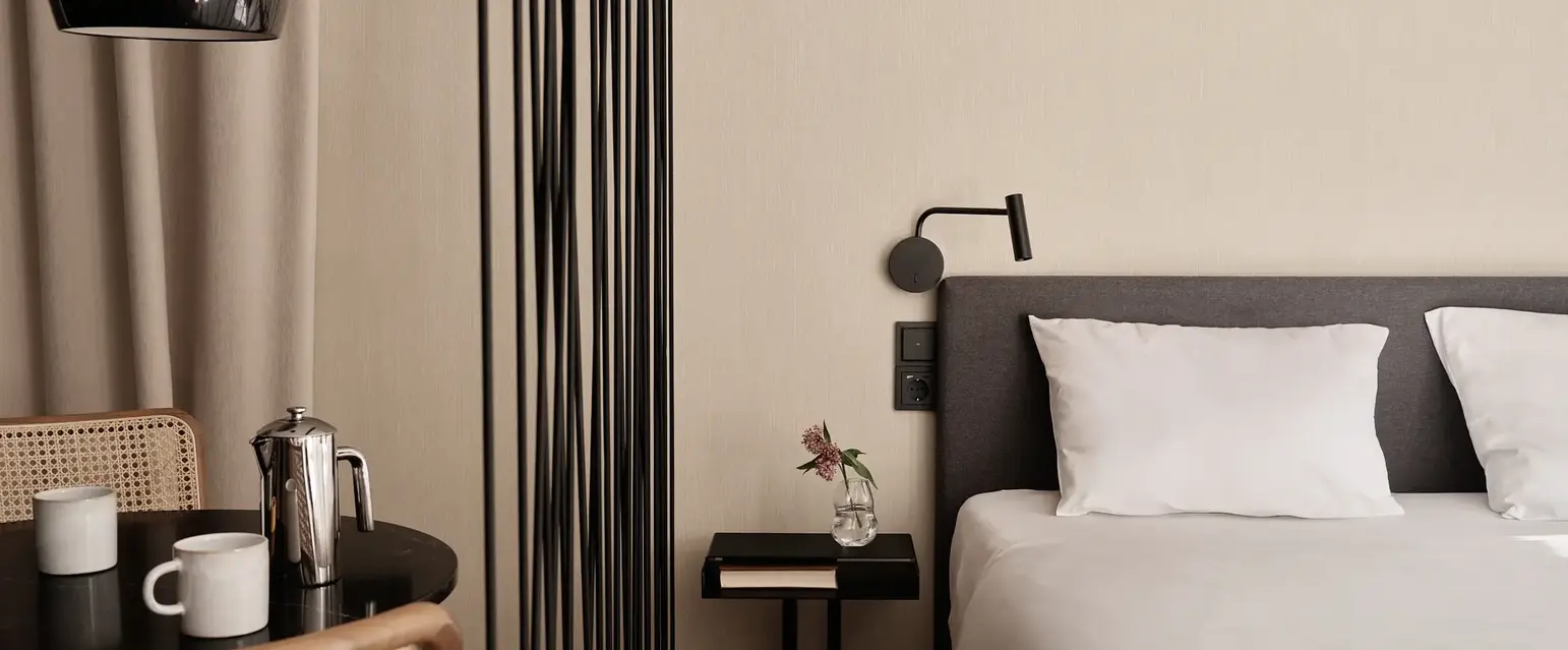 a bed with a white sheet and a black table