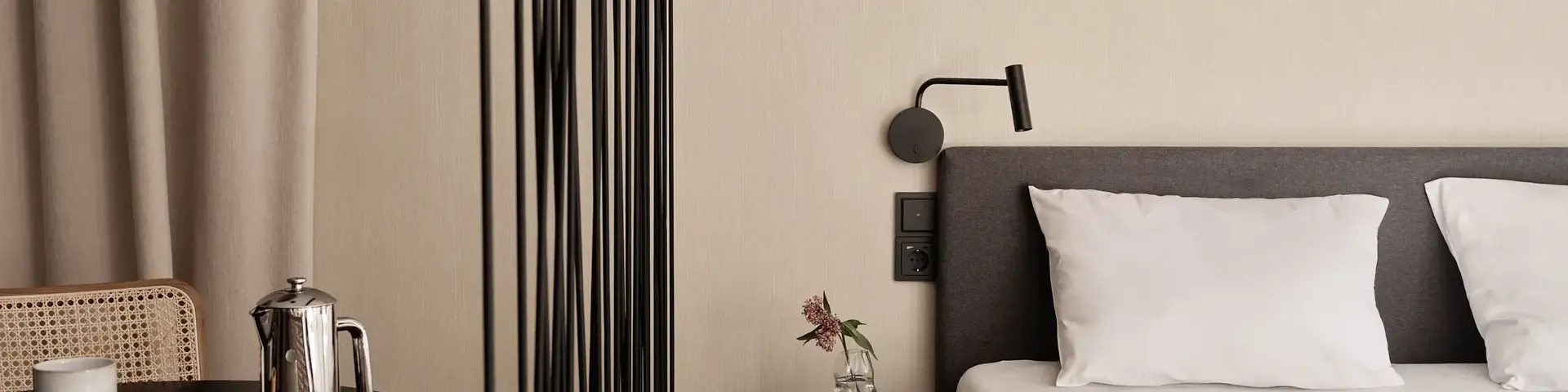 a bed with a white sheet and a black table