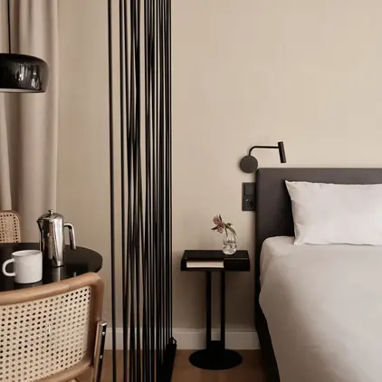 a bed with a white sheet and a black table