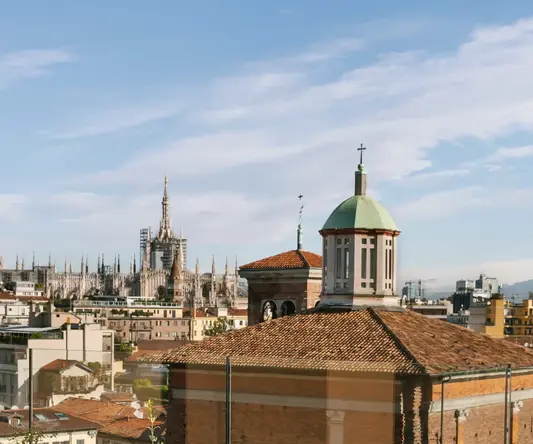 a table and chairs on a rooftop overlooking a city