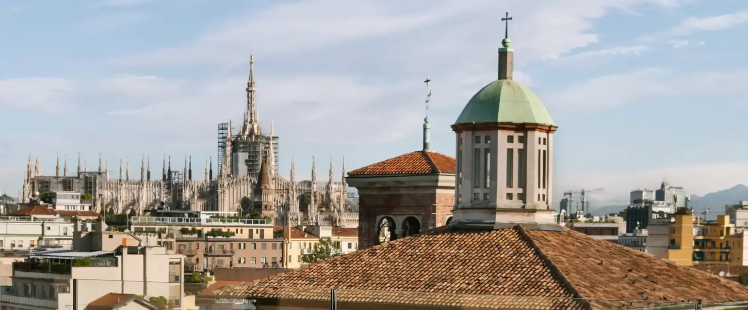 a table and chairs on a rooftop overlooking a city