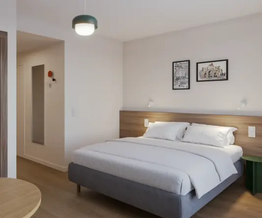 a bedroom with a bed and a round table