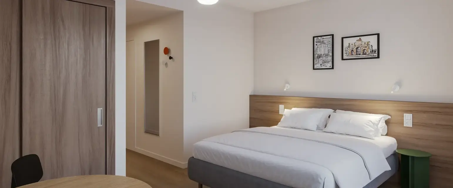 a bedroom with a bed and a round table