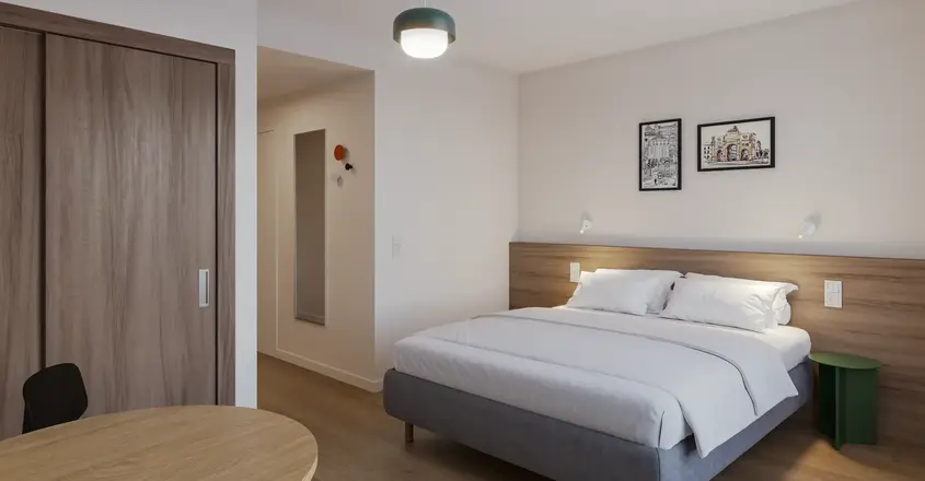 a bedroom with a bed and a round table