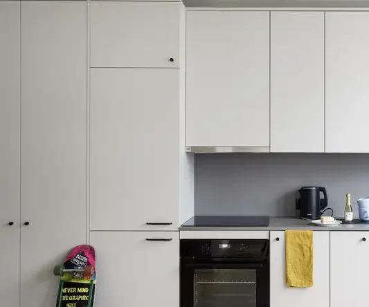 a kitchen with white cabinets and a black stove