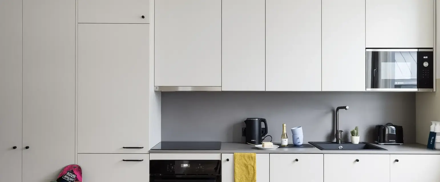 a kitchen with white cabinets and a black stove