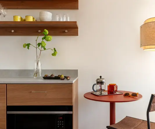 a kitchen with a table and a microwave