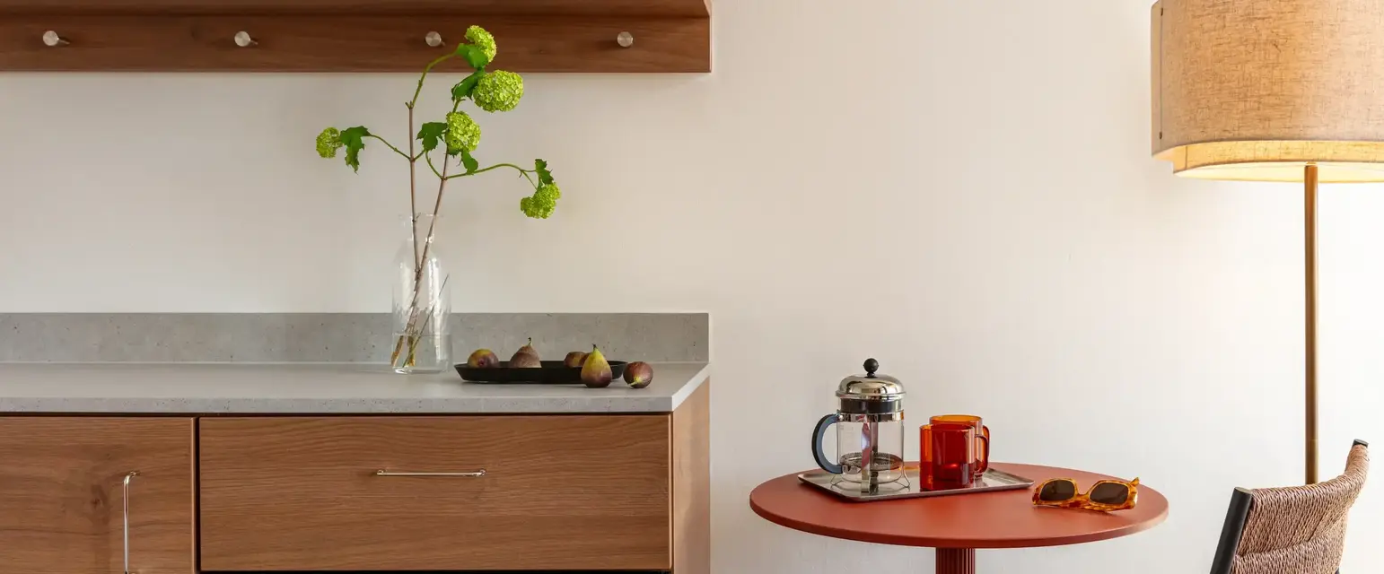 a kitchen with a table and a microwave