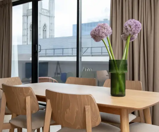 a table with chairs and flowers in it