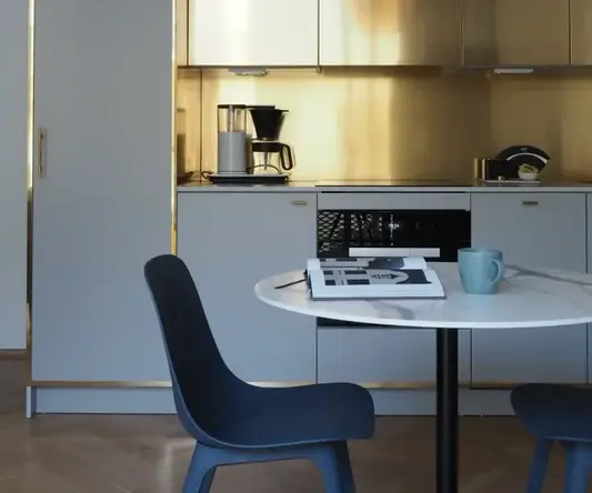a kitchen with a round table and chairs