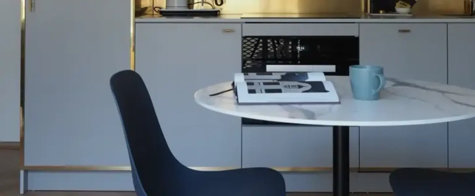a kitchen with a round table and chairs