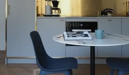 a kitchen with a round table and chairs