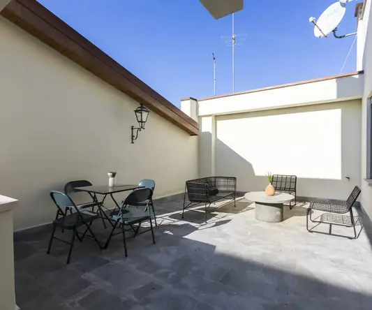 a patio with chairs and a satellite dish