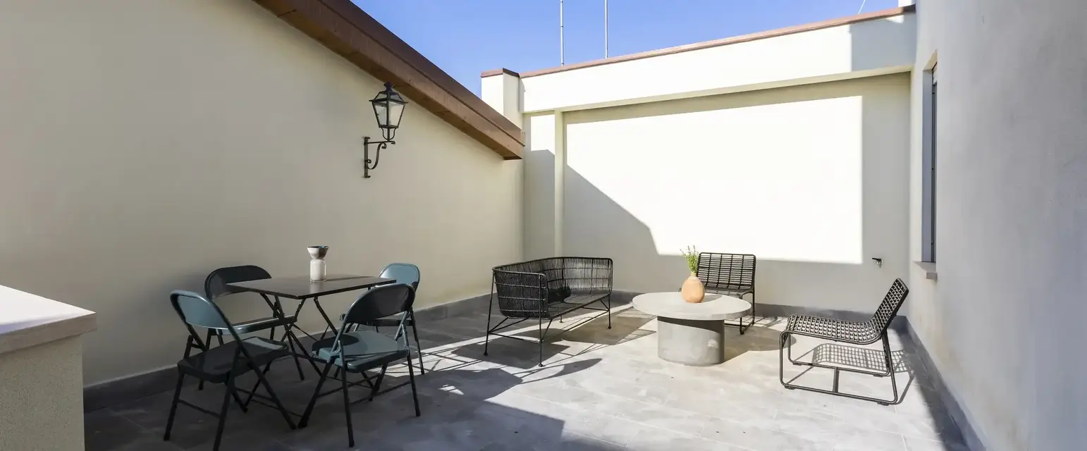 a patio with chairs and a satellite dish