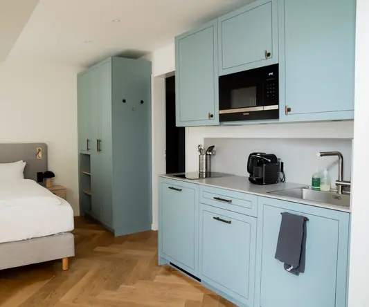 a bedroom with a bed and a microwave