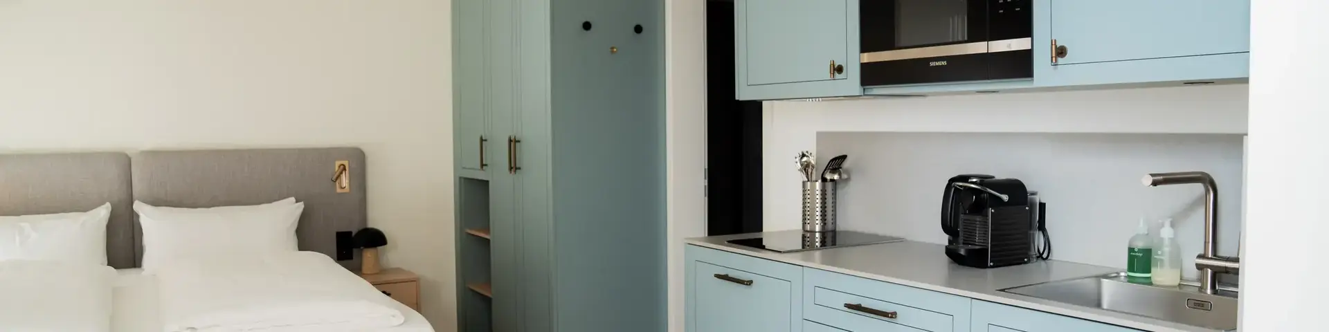 a bedroom with a bed and a microwave