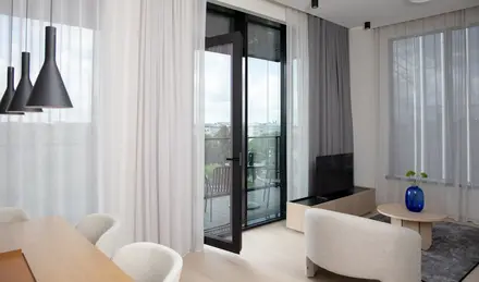 a room with a glass door and a table