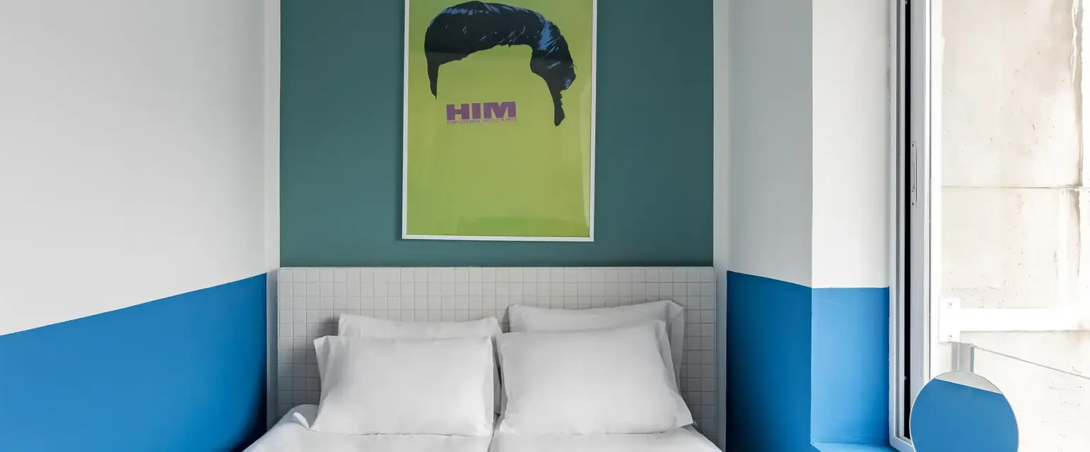 a bed with white sheets and towels on it