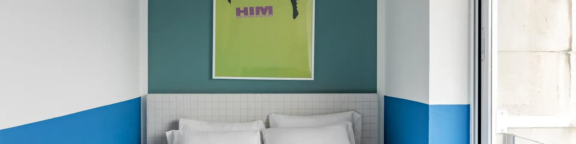 a bed with white sheets and towels on it