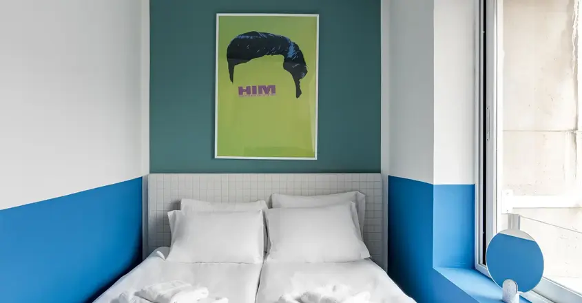 a bed with white sheets and towels on it