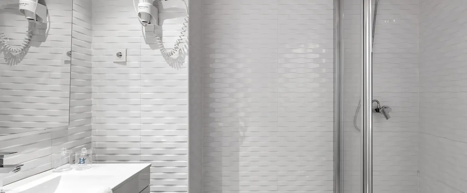 a bathroom with a shower and sink