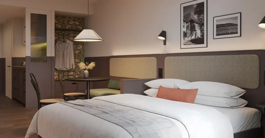 a bed with a table and chairs in a room