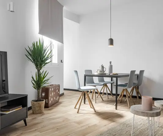 a dining room with a table and chairs