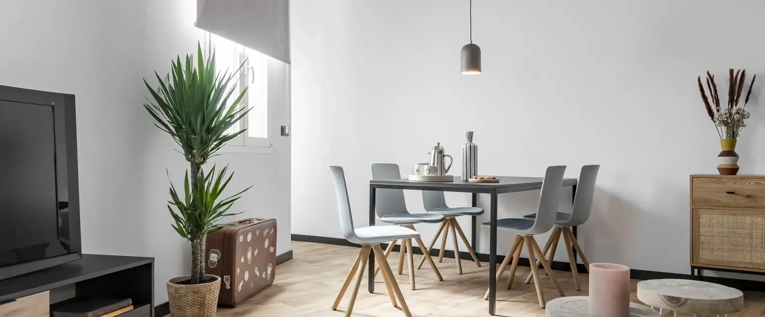 a dining room with a table and chairs
