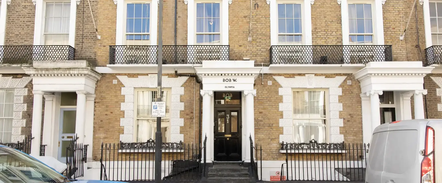 a blue car parked in front of a building