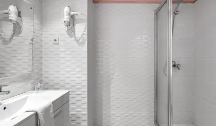 a bathroom with a shower and sink