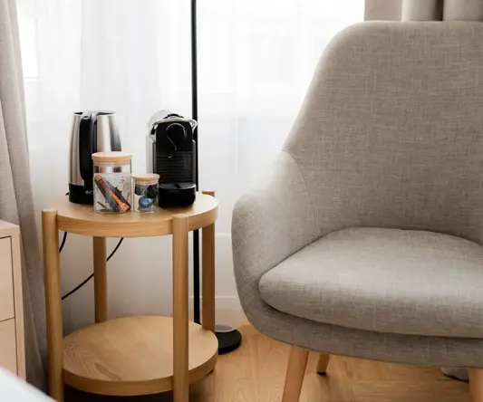 a table with coffee cups and a coffee maker on it