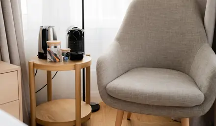 a table with coffee cups and a coffee maker on it