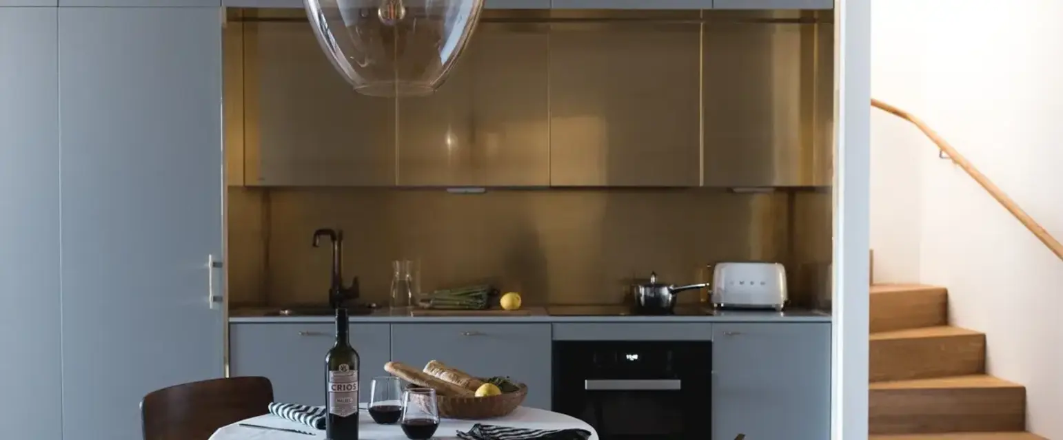 a table with a bottle of wine and a glass of wine on it