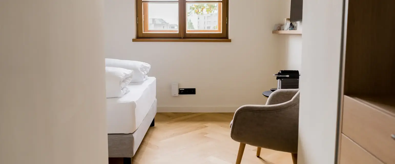 a room with a bed and a chair