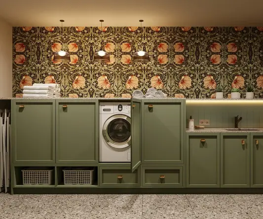 a laundry room with green cabinets and a washing machine