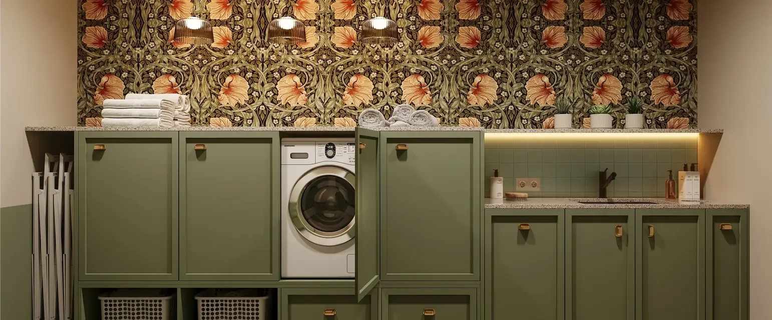 a laundry room with green cabinets and a washing machine