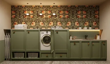 a laundry room with green cabinets and a washing machine
