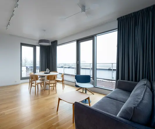 a living room with a couch and chairs