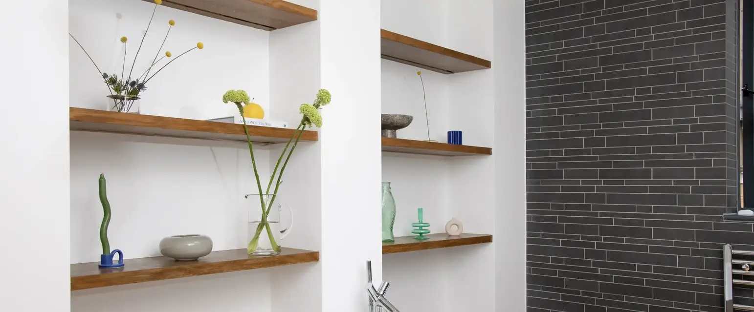 a bathtub and shelves in a bathroom