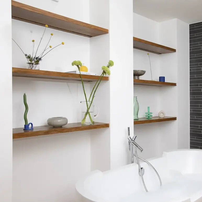 a bathtub and shelves in a bathroom