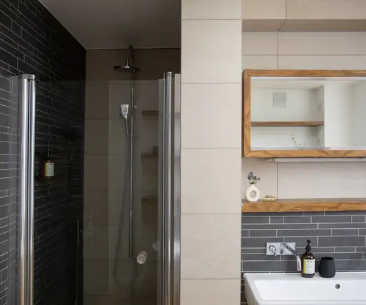 a bathroom with a shower and sink