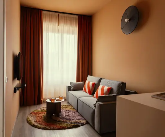 a couch in a room with a round table and red curtains