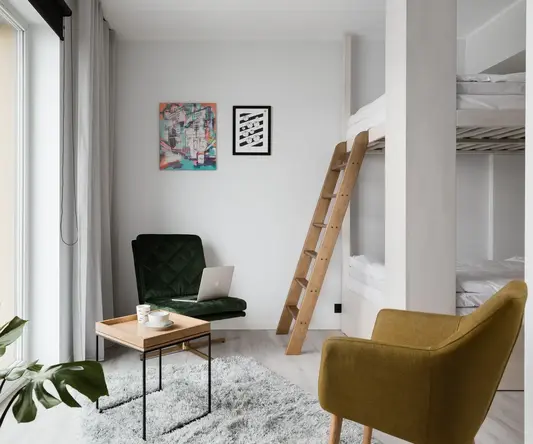 a room with a bunk bed and a chair