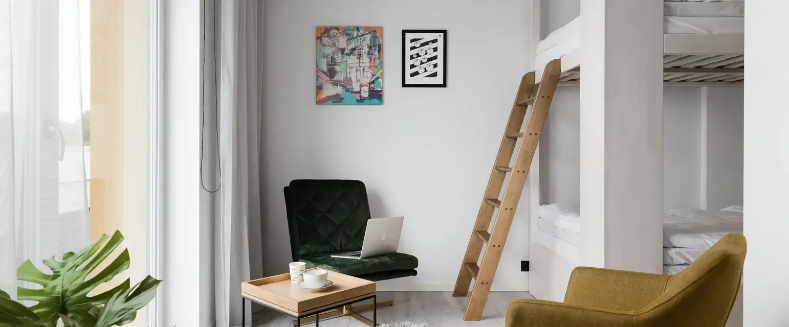 a room with a bunk bed and a chair